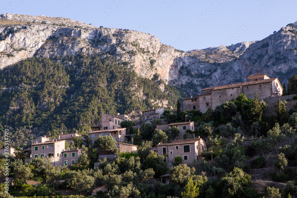 Beautiful view of old mountain village Deia in Mallorca on a sunny day. Deia traditional stone village in Majorca Tramuntana mountain
