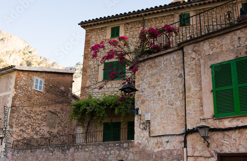 Beautiful view of old mountain village Deia in Mallorca on a sunny day. Deia traditional stone village in Majorca Tramuntana mountain © romeof