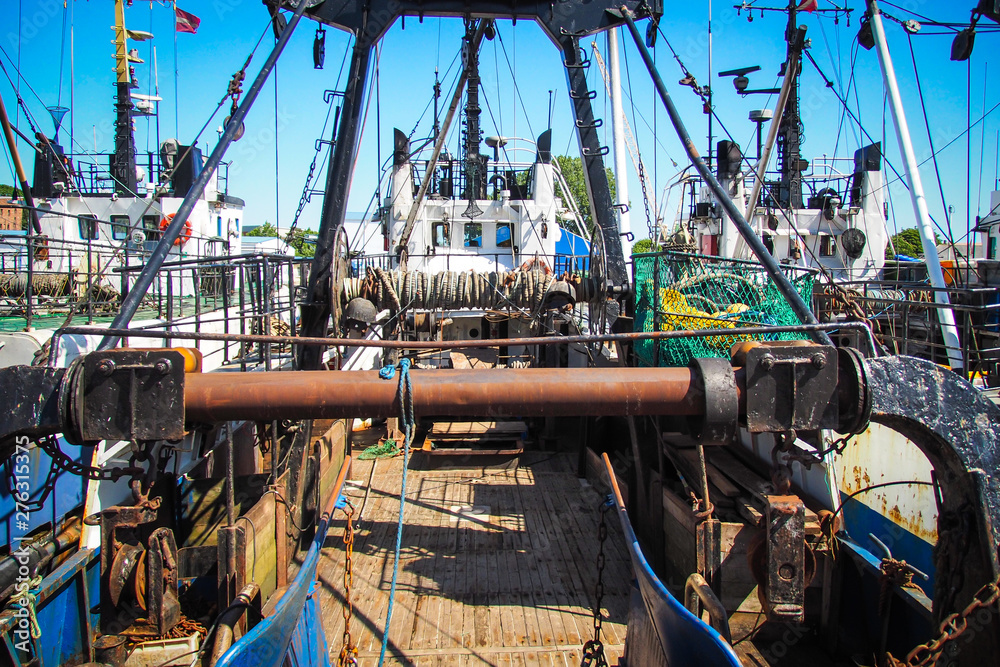 Fototapeta premium Small fishing vessel in port in summer