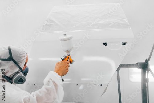 Принти на полотні Professional car painter painting door of a car with primer.