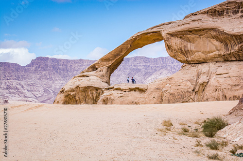 Natural arch in desert with sandstone and granite rock Wadi Rum in Jordan