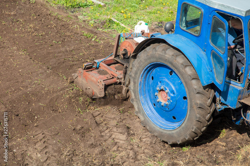 Tractor plowing soil in spring