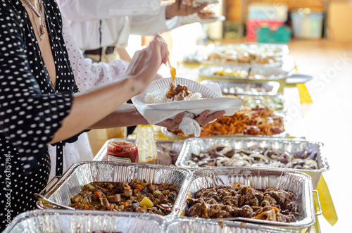A self service buffet of Filipino dishes at a party.