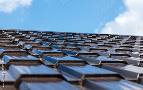 The roof of metal on a background of blue sky