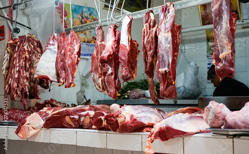 shop and stall of a butcher in Huaraz selling fesh meat in the market hall in Huaraz
