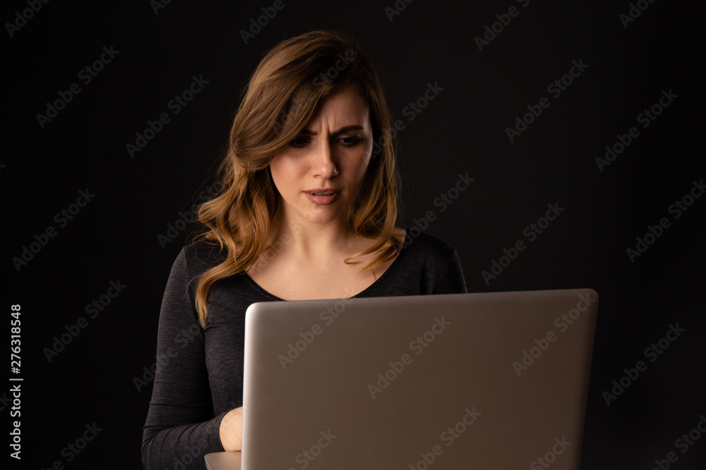 Worried woman with laptop isolated. Computer problem concept Worried woman with laptop isolated. Computer problem concept
