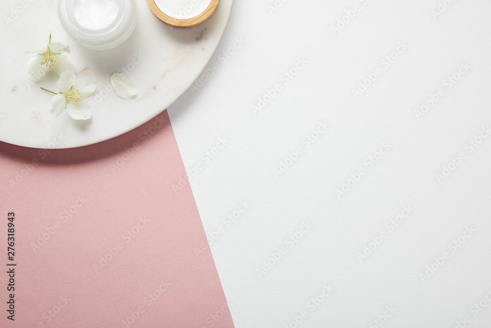 top view of plate with cream and flowers on white pink surface - obrazy, fototapety, plakaty 