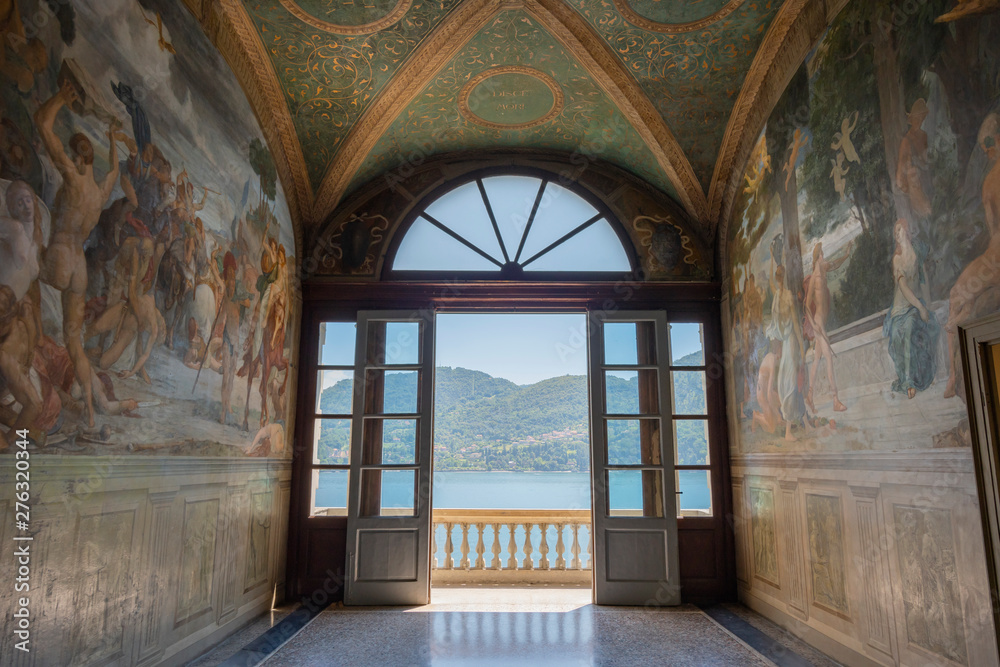 Doorway to balcony with distant view of Como Villa Carlotta Tremezzo, Como Lake, Italy.