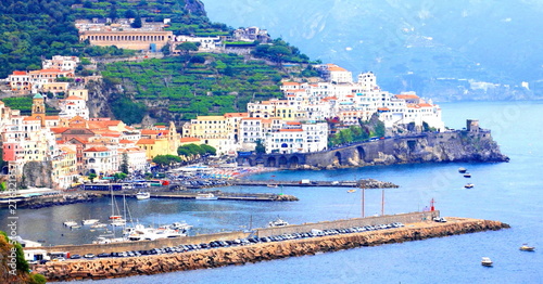 Panoramic scenic view of Amalfi Coast, Campania, Italy, in summer with traditional Italian architecture on mountains, beautiful blue sea and luxury yachts