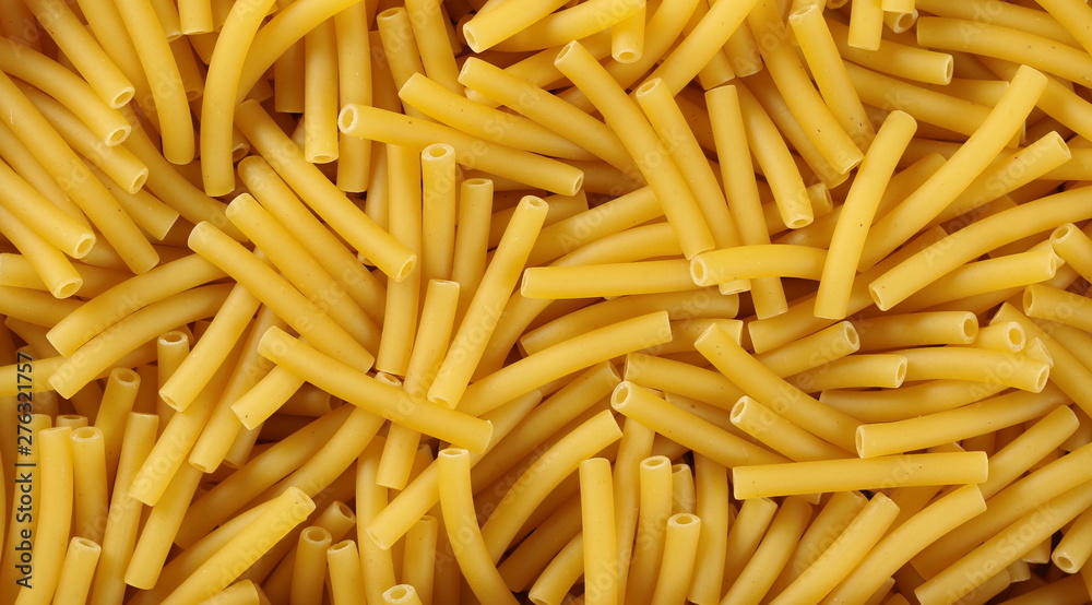 Macaroni, raw pasta in wooden food basket background and texture, top view Macaroni, raw pasta in wooden food basket background and texture, top view