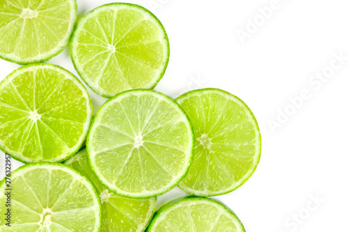Vibrant lime slices, shot from above on a white background with copy space