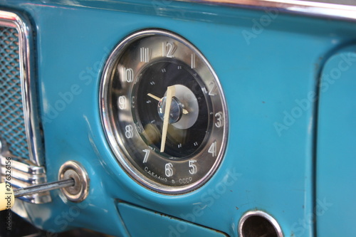 clock on a vintage car panel
