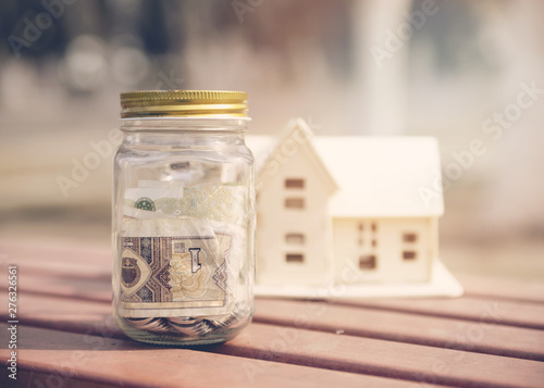 Savings jar with house miniature