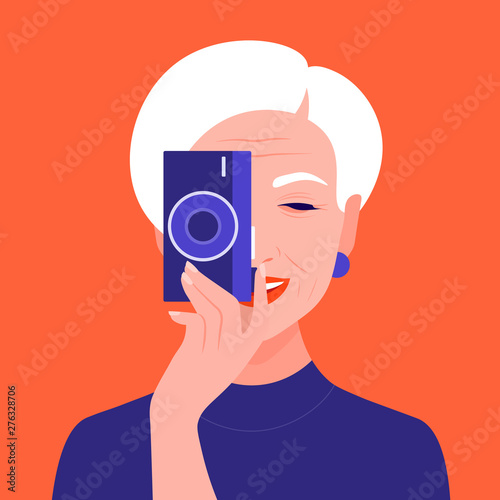 An old female photographer holds a camera and takes a picture. Tourist and blogger. Grandmother. Vector flat illustration