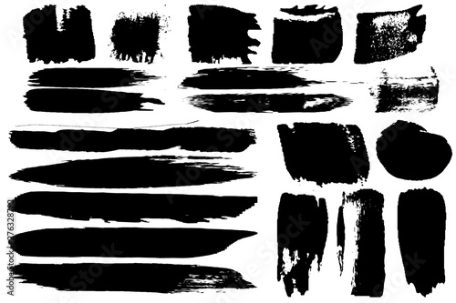 A set of grunge vector brushes. Strokes of black paint on white paper.