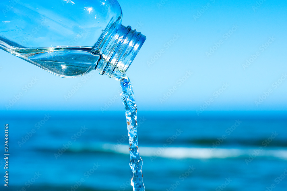 water flowing out of a glass reusable bottle water flowing out of a glass reusable bottle