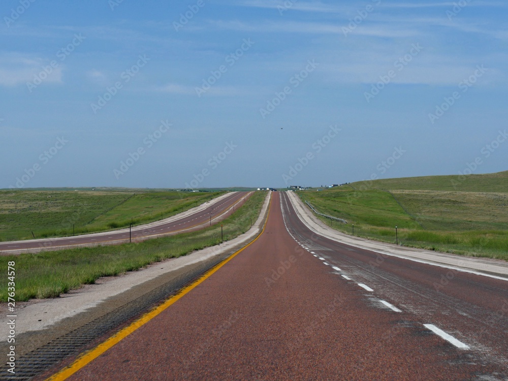 Straight paved red asphalt at Powder River Road in Gillette, Wyoming Straight paved red asphalt at Powder River Road in Gillette, Wyoming