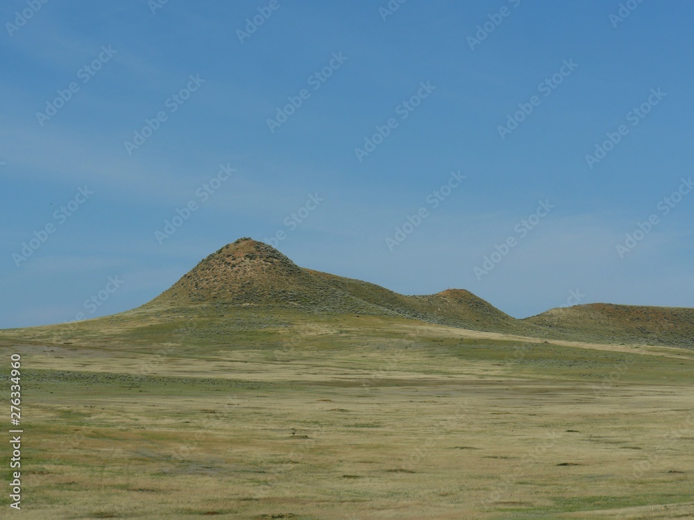 Rolling hills and green hillsides outside of Gillette, Wyoming.