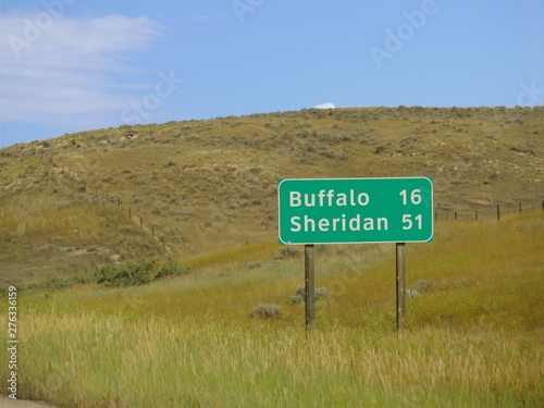 Roadside sign with distances to Buffalo and Sheridan, Wyoming. photo