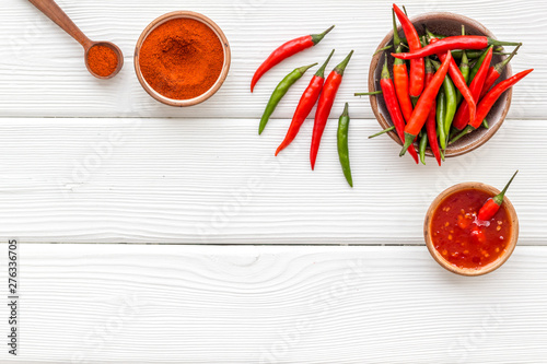 Dry powder and fresh red chilli pepper as food ingredient on white wooden table background top view mockup