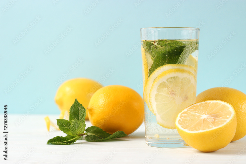 water with lemon on a colored background water with lemon on a colored background