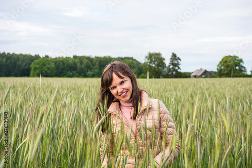 Woman in the field. Beautiful brunette in rye field.