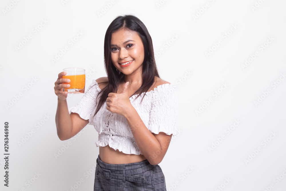 Young Asian woman thumbs up drink orange juice. Young Asian woman thumbs up drink orange juice.