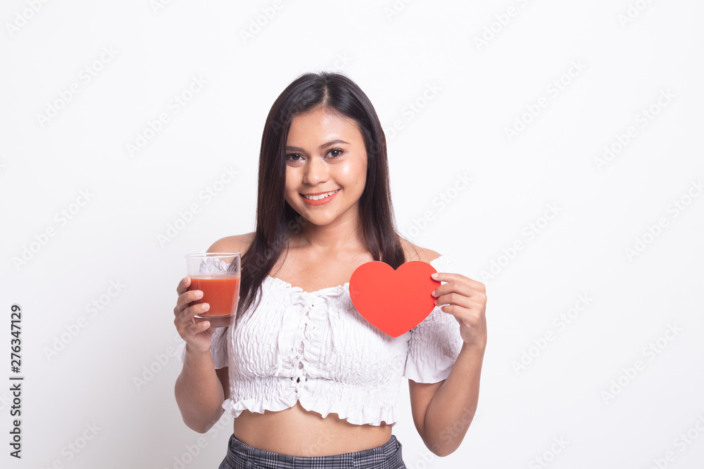 Young Asian woman with tomato juice and red heart. Young Asian woman with tomato juice and red heart.