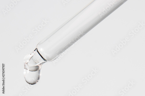 Pipette drop Water to white background photo