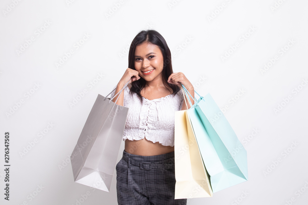 Beautiful young Asian woman with shopping bags. Beautiful young Asian woman with shopping bags.