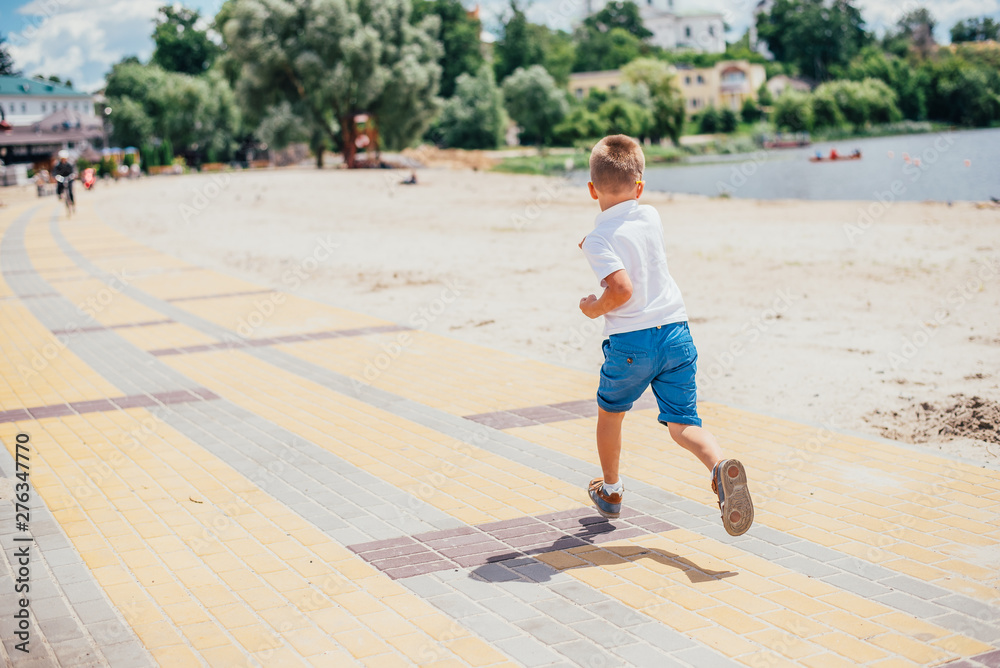 boy running on beach boy running on beach