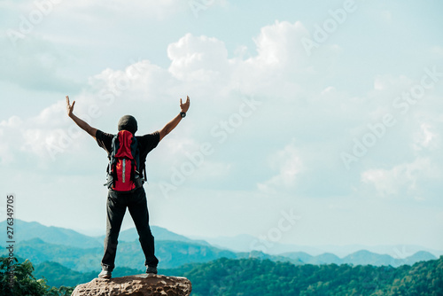 Hiker asian man happy feeling freedom good and strong weight victorious facing on the natural mountain. Travel Concept