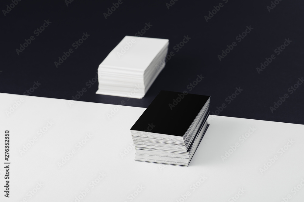stacks of empty business cards on divided black and white background stacks of empty business cards on divided black and white background
