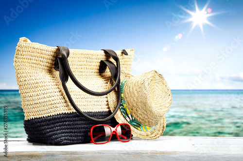 Summer bag on desk and sea landscape 