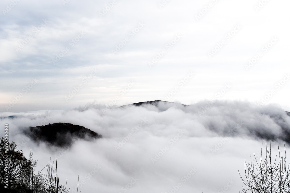 Aerial view of mountains engulfed in clouds