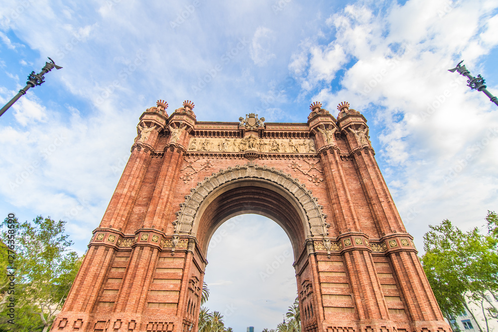 Barcelona, Spain - April, 2019: Arc de Triomf de Barcelona is a triumphal arch in the city of Barcelona in Catalonia, Spain during a cloudy day.