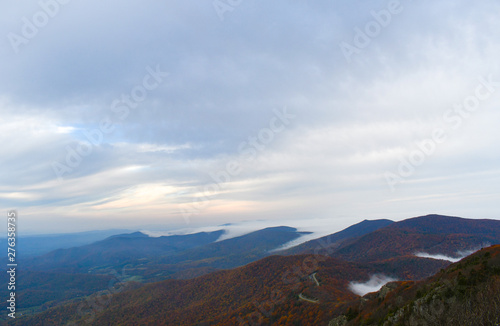 Aerial twilight panorama of mountain forests in autumn colors