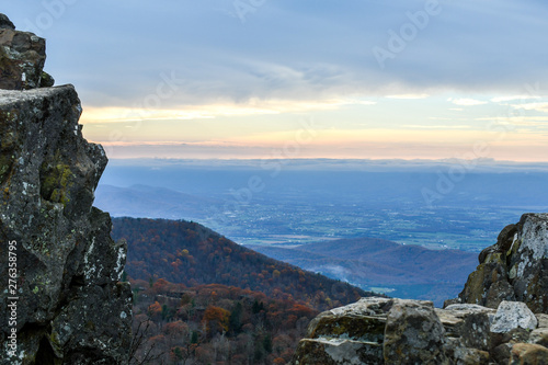 Aerial twilight panorama of mountain forests in autumn colors