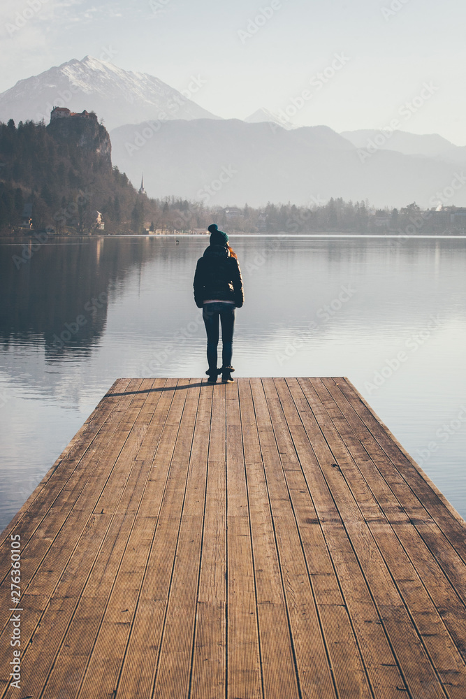 Young lady on the lake pier, early morning. Young lady on the lake pier, early morning.