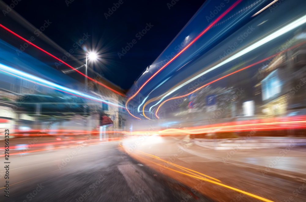 Night city and blured lights from cars. Traffic background in the town. Composition with transport traffic. Transportation - image