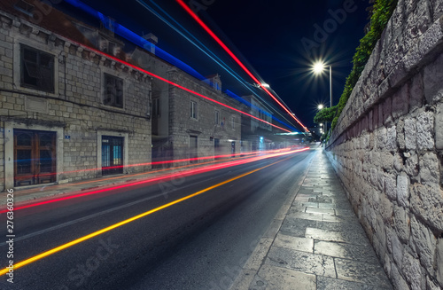 Night city and blured lights from cars. Traffic background in the town. Composition with transport traffic. Transportation - image