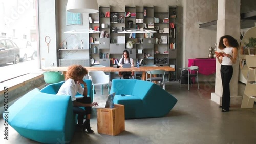 three multiracial young businesswomen working in modern coworking office – freelance, interaction, communication