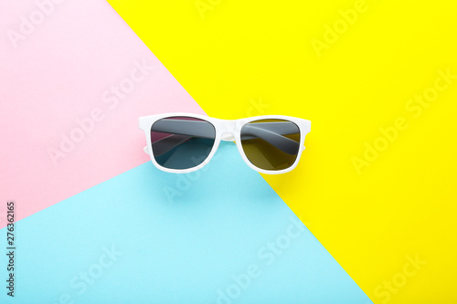 Modern sunglasses on colorful background