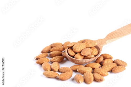 Almonds in wooden spoon isolated on white background