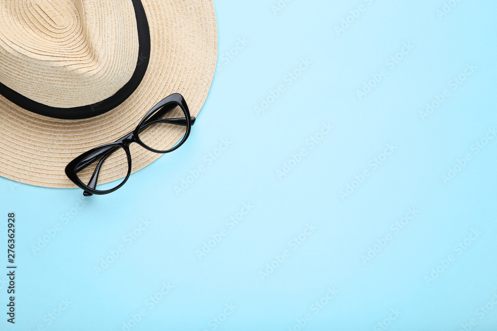 Fashion hat with glasses on blue background - obrazy, fototapety, plakaty 