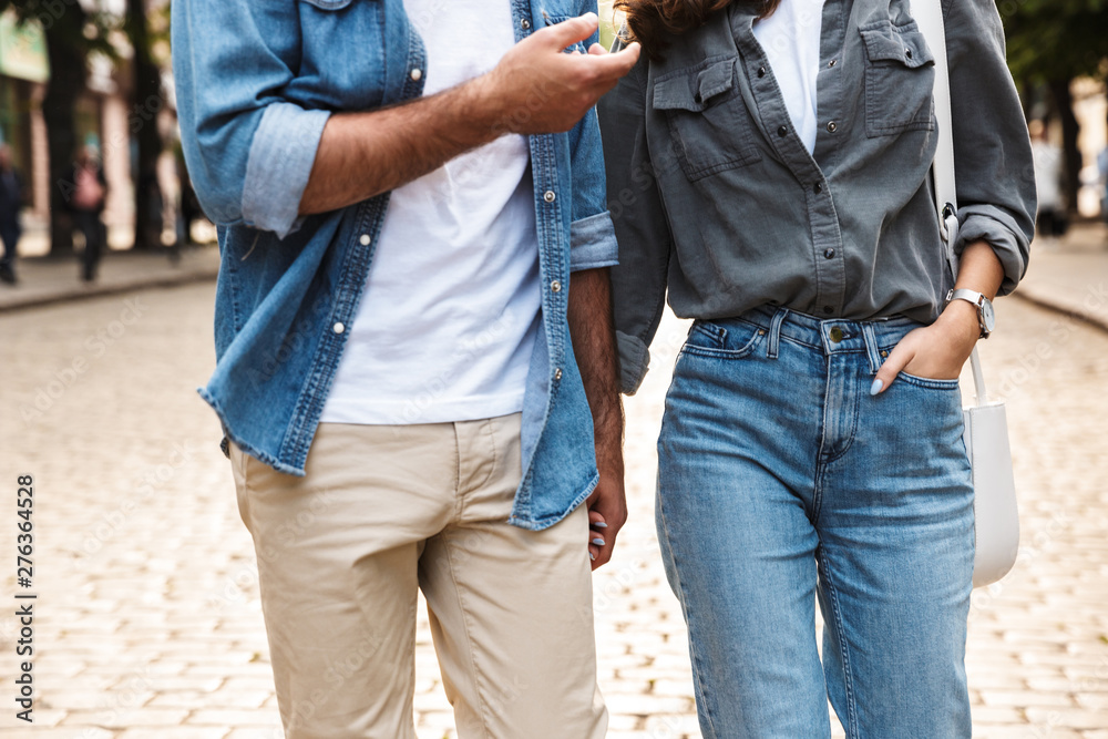 Beautiful young couple in love walking outdoors at the city street Beautiful young couple in love walking outdoors at the city street