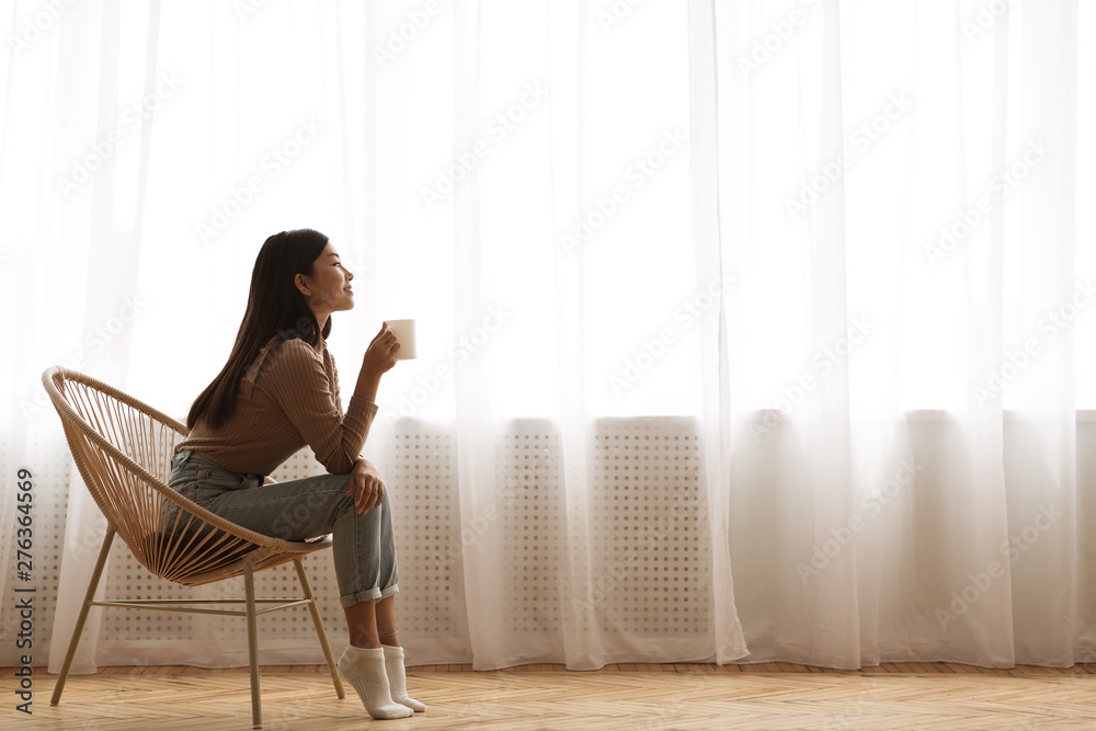 Girl Sitting In Modern Chair, Enjoying Morning Coffee