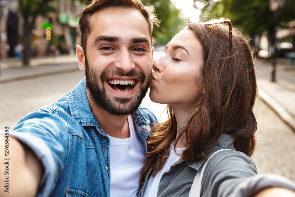 Fototapeta premium Beautiful young couple in love standing outdoors