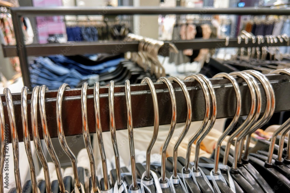 Clothes hang on a shelf in a designer clothes store. Clothes hang on a shelf in a designer clothes store.