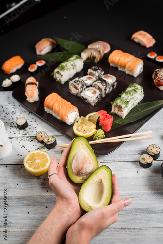 Sushi set with salmon, eel, tuna, avocado, cream cheese Philadelphia, caviar, chuka. Sushi menu. Japanese food on black and white background